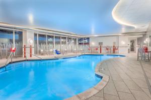 a large swimming pool with blue water in a building at Hampton Inn & Suites Madison Downtown in Madison