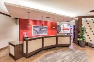 an office lobby with a red accent wall at Hampton Inn & Suites Madison Downtown in Madison