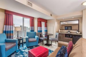 a living room with a couch and chairs and a kitchen at Hampton Inn & Suites Madison Downtown in Madison