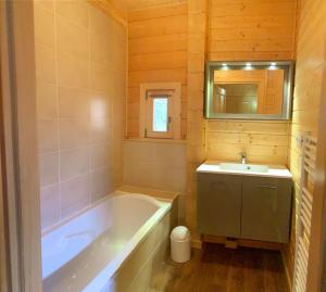 La salle de bains est pourvue d'une baignoire et d'un lavabo. dans l'établissement Oreeduloup Chalet Japp'loup 10/12 Pers., à Saint-Étienne-en-Dévoluy
