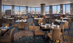 a restaurant with tables and chairs and a view of the city at Hilton Garden Inn Austin Downtown-Convention Center in Austin