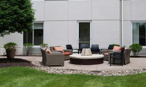 a patio with couches and chairs in front of a building at Hilton Garden Inn BWI Airport in Linthicum Heights