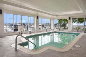 a swimming pool in a large room with windows at Hilton Garden Inn Kent Island in Grasonville