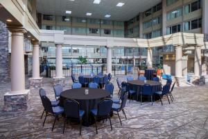 a courtyard with tables and chairs in a building at DoubleTree by Hilton Cleveland – Westlake in Westlake