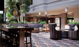a lobby of a hotel with a table and chairs at Embassy Suites by Hilton Dallas Near the Galleria in Dallas
