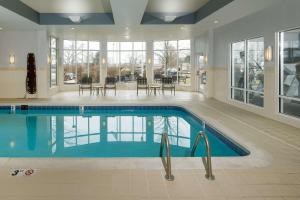 een zwembad in een grote kamer met een zwembad bij Hilton Garden Inn Cincinnati Blue Ash in Blue Ash