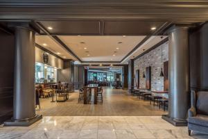 a lobby with tables and chairs in a building at Hilton Alexandria Old Town in Alexandria