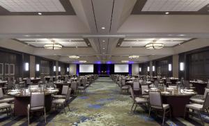 a banquet hall with tables and chairs in a room at Hilton Parsippany in Parsippany