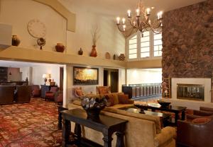 a living room with a couch and a fireplace at Embassy Suites by Hilton Flagstaff in Flagstaff