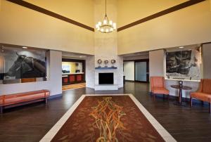 a hotel lobby with a fireplace and a waiting room at Hampton Inn & Suites N Ft Worth-Alliance Airport in Roanoke