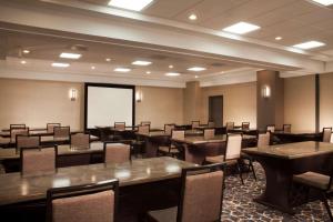 a conference room with tables and chairs and a whiteboard at Embassy Suites by Hilton Houston Near the Galleria in Houston +24 photos
