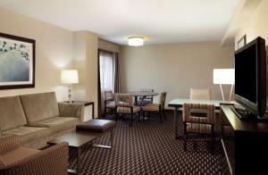 a living room with a couch and a dining room at Embassy Suites by Hilton Houston Near the Galleria in Houston