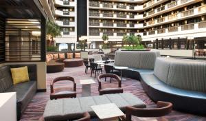 a restaurant with tables and chairs and a building at Embassy Suites by Hilton Las Vegas in Las Vegas