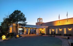 a large building with a clock tower on top of it at Hilton Santa Fe Historic Plaza in Santa Fe