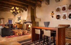 a living room with a table and a fireplace at Hilton Santa Fe Historic Plaza in Santa Fe