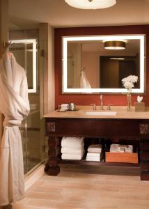 a bathroom with a sink and a mirror at Hilton Santa Fe Historic Plaza in Santa Fe