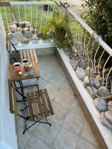 a wooden bench sitting on top of a balcony at moTIVATion apartment in Tivat