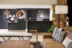 a living room with a couch and clocks on the wall at Hilton Santa Cruz Scotts Valley in Santa Cruz