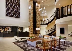 a living room with a couch and a table at Hilton Santa Cruz Scotts Valley in Santa Cruz