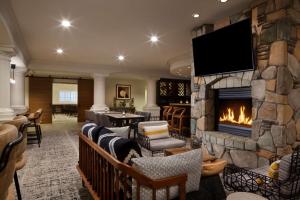 a living room with a fireplace and a tv at Hilton Santa Cruz Scotts Valley in Santa Cruz
