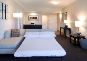 a living room with a couch and a bed at Hilton Santa Cruz Scotts Valley in Santa Cruz