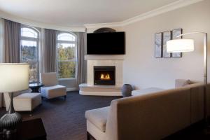 a living room with a couch and a fireplace at Hilton Santa Cruz Scotts Valley in Santa Cruz