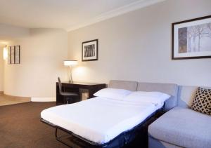 a hotel room with a bed and a couch at Hilton Santa Cruz Scotts Valley in Santa Cruz