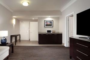 a living room with a large flat screen tv at Hilton Santa Cruz Scotts Valley in Santa Cruz