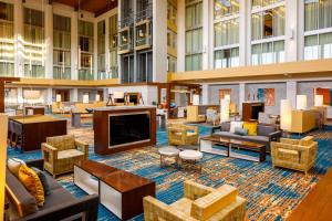 a hotel lobby with couches and a large television at DoubleTree by Hilton Pittsburgh - Cranberry in Cranberry Township