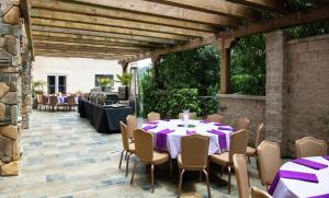 a patio with a table and chairs with purple table cloth at Hilton Santa Cruz Scotts Valley in Santa Cruz