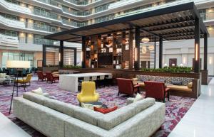 a lobby with a couch and chairs in a building at Embassy Suites by Hilton Walnut Creek in Walnut Creek
