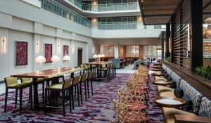 a restaurant with tables and chairs in a building at Embassy Suites by Hilton Walnut Creek in Walnut Creek