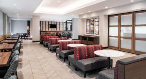 a dining room with chairs and tables and apodcast at Embassy Suites by Hilton Walnut Creek in Walnut Creek +36 photos