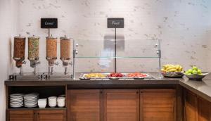 a kitchen with a counter with food on it at Embassy Suites by Hilton Walnut Creek in Walnut Creek