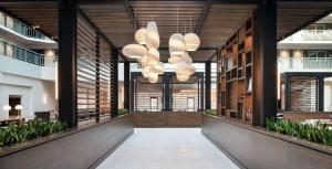 a hallway in an office building with a large chandelier at Embassy Suites by Hilton Walnut Creek in Walnut Creek