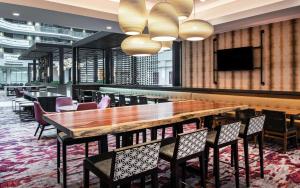 a dining room with a large wooden table and chairs at Embassy Suites by Hilton Walnut Creek in Walnut Creek