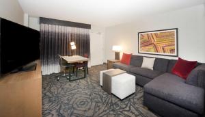 a living room with a couch and a desk at Embassy Suites by Hilton Walnut Creek in Walnut Creek