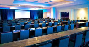 a conference room with blue chairs and a screen at Embassy Suites by Hilton Walnut Creek in Walnut Creek