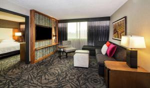 a hotel room with a couch and a bed at Embassy Suites by Hilton Walnut Creek in Walnut Creek