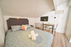 a bedroom with a bed with a cross on it at Le Salengro - Studio cosy - métro Charpennes in Villeurbanne