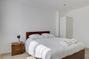 ein Schlafzimmer mit einem großen weißen Bett mit Handtüchern darauf in der Unterkunft Charming house in Faches-Thumesnil - Welkeys in Faches-Thumesnil