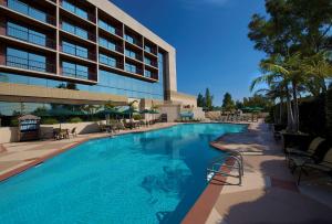a large swimming pool in front of a building at Hilton Orange County/Costa Mesa in Costa Mesa