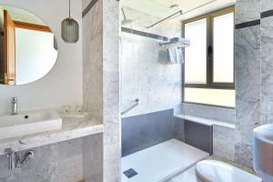 a bathroom with a sink and a toilet and a mirror at Hotel Torre Del Conde in San Sebastián de la Gomera