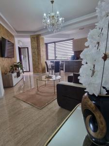 a living room with a couch and a table at Ella Luxury Apartament in Năvodari