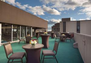 a rooftop patio with tables and chairs on a building at Hilton Boston Back Bay in Boston
