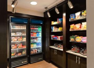 a kitchen with two refrigerators with food and drinks at Hampton Inn Lawrenceville in Lawrenceville