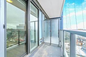 an empty balcony in a building with glass windows at Luxurious 1BR Condo - Stunning City Views in Kitchener