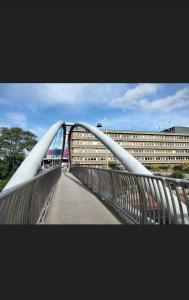 a bridge over a road in front of a building at KENT, DARTFORD STATION APARTMENTs in Dartford