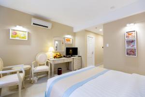 Ένα ή περισσότερα κρεβάτια σε δωμάτιο στο Hotel L'Odéon Phu My Hung +76 φωτογραφίες