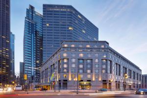 a large glass building in a city with buildings at The Logan Philadelphia, Curio Collection by Hilton in Philadelphia